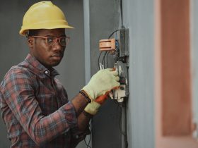 An electrician repairing a fuse box