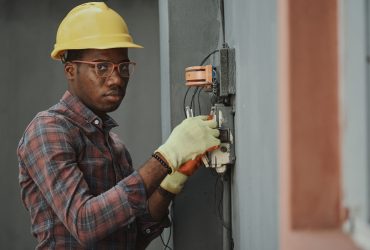 An electrician repairing a fuse box