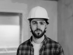 Man in white hard hat and plaid shirt