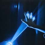 Photo of person s hand with blue light