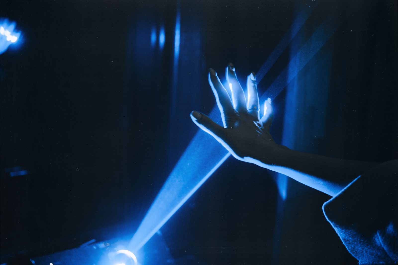 Photo of person s hand with blue light