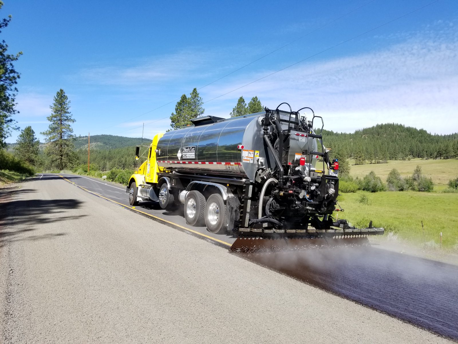 Truck pouring asphalt on road