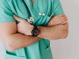 Unrecognizable crop man in wristwatch with stethoscope